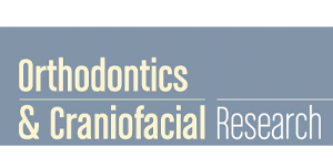 Featuring a clean, professional design, the "Orthodontics & Craniofacial Research" journal logo for Koerich Orthodontics in Charlotte, Indian Trail, or Monroe, NC uses a blue-gray background with white and yellow text to highlight its focus on orthodontics and craniofacial research.