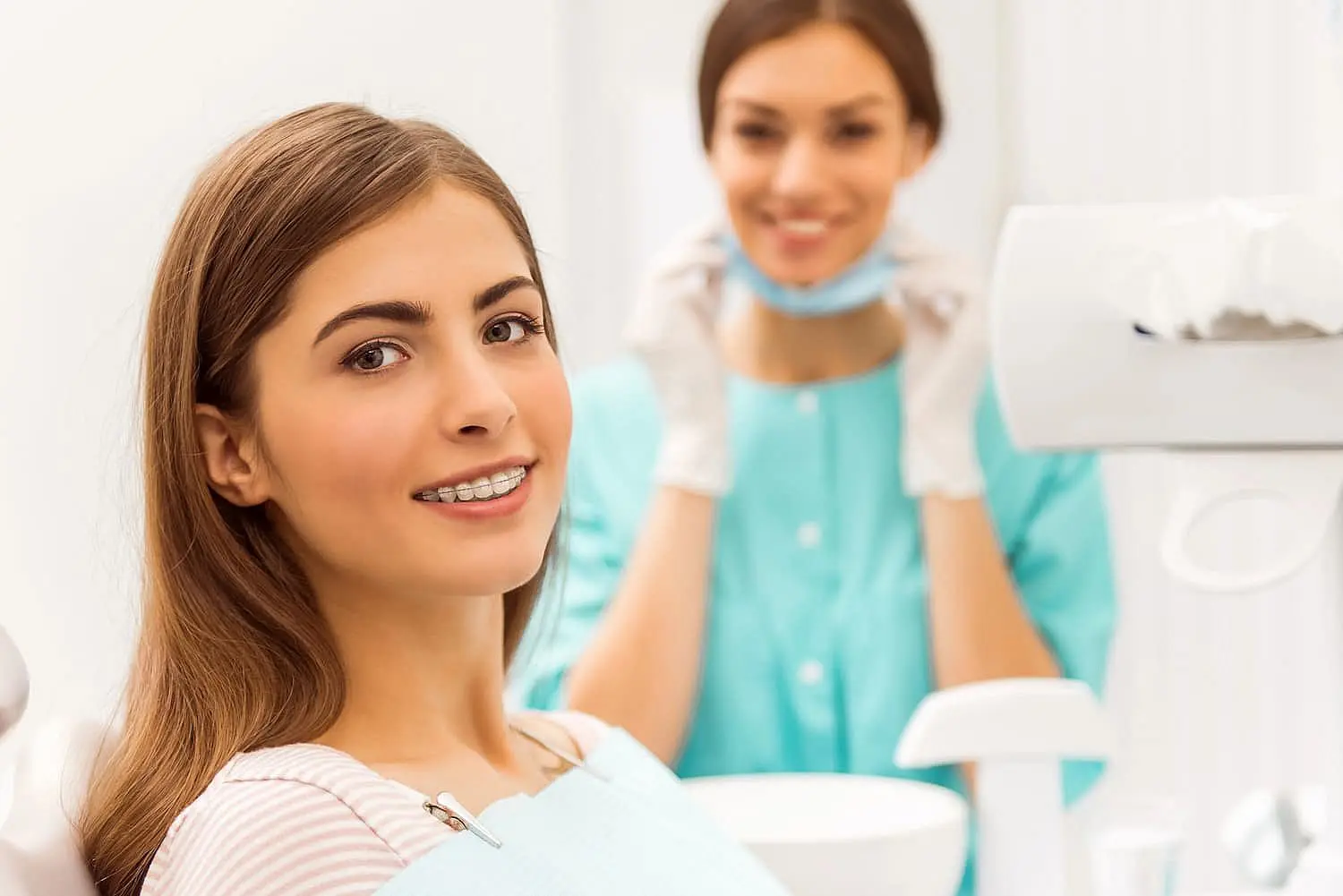 A woman with sparkling braces beams a radiant smile at Koerich Orthodontics in Charlotte, NC