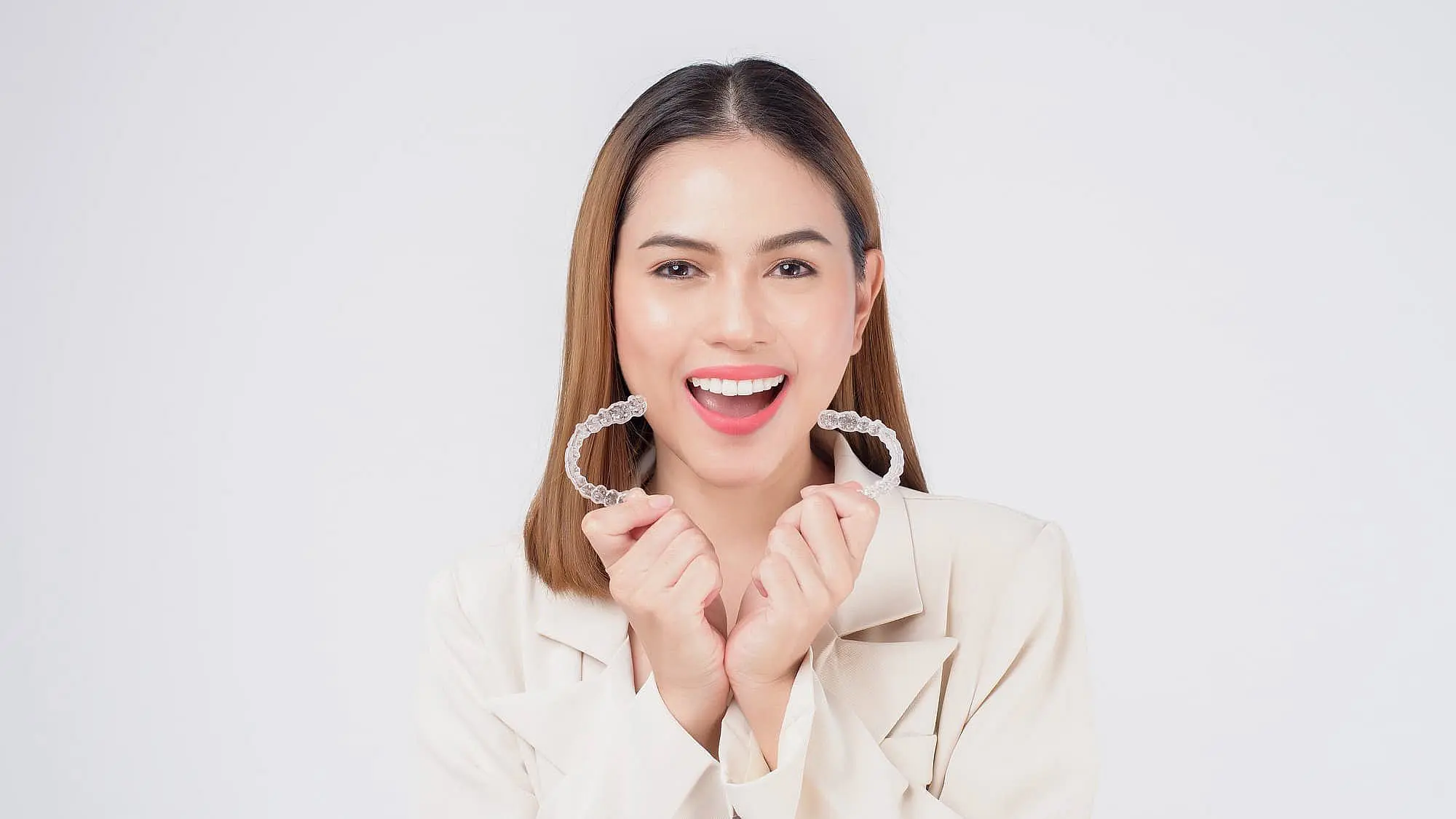 A woman hold invisalign with both hand at Koerich Orthodontics in Charlotte, NC