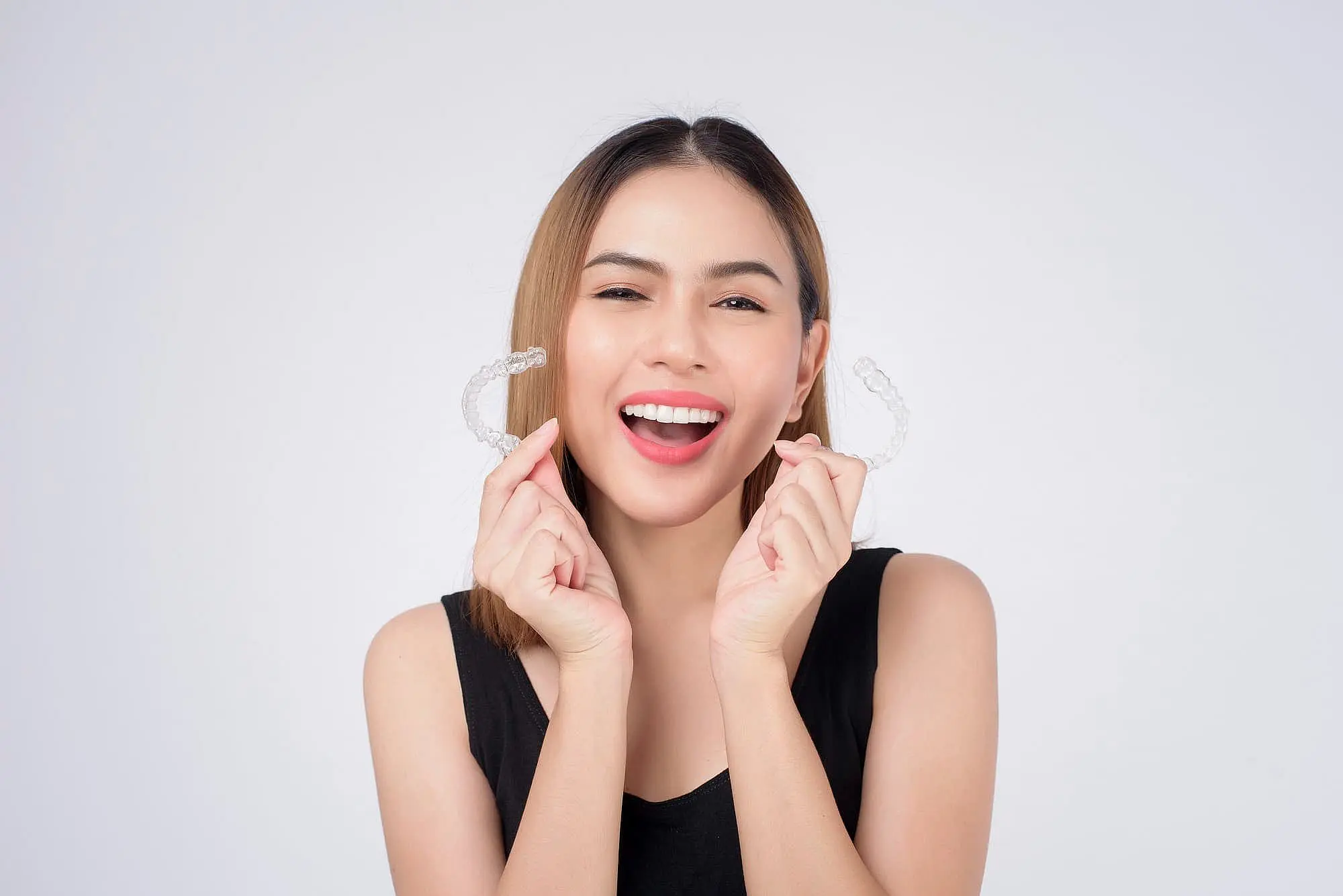 A woman hold invisalign with both hand representing best orthodontics service at Koerich Orthodontics in  Indian Trail, NC.