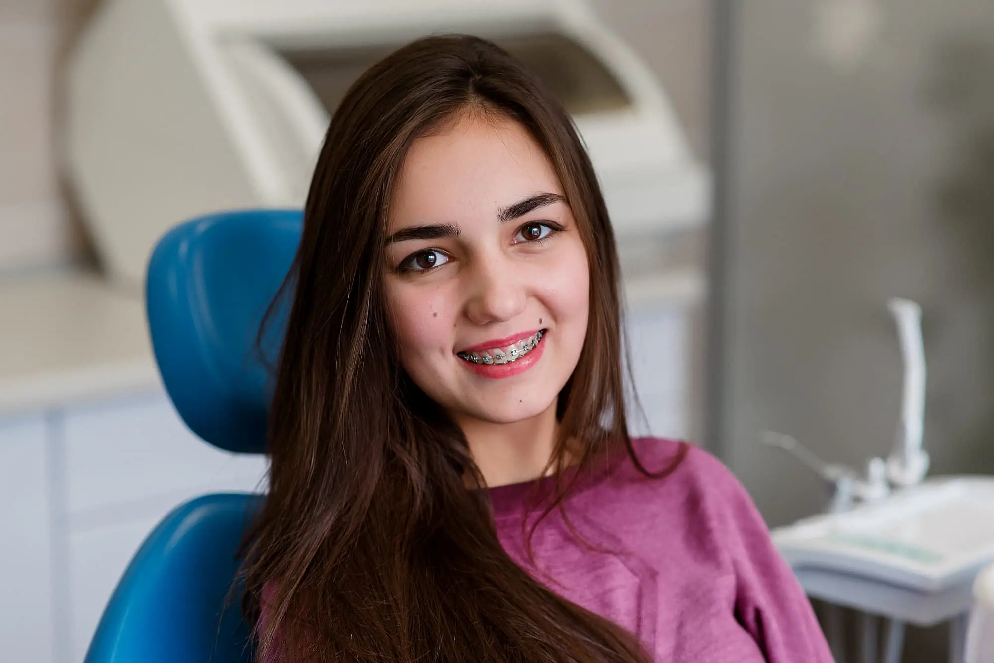 Smiling young woman learning about affordable braces cost solutions  in Charlotte, Indian Trail or Monroe, NC