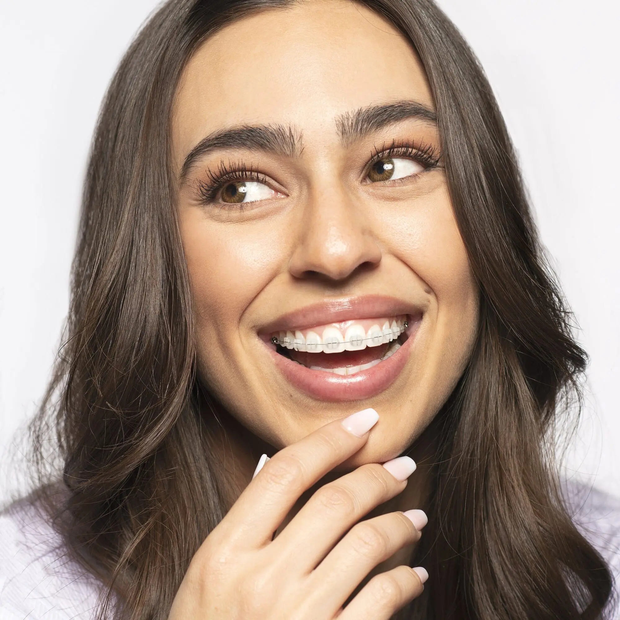Smiling patient wearing LightForce Clear Braces, showcasing custom fit and discreet appearance for confident orthodontic care in Charlotte, Indian Trail, and Monroe NC.