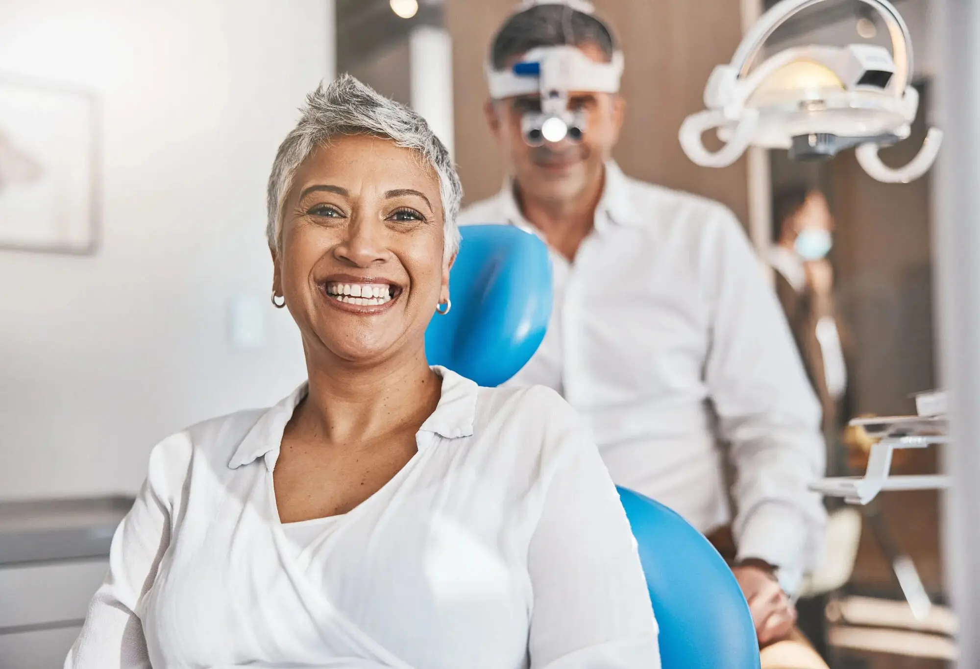 A patient is sitting in a dental chair and a dentist during journey adult orthodontics to his patient at Koerich Orthodontics in Charlotte, Indian Trail and Monroe, NC.