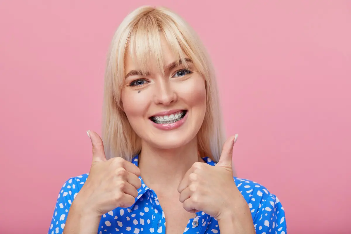 Woman smiling, wearing clear braces in outdoor in Charlotte, Indian Trail and Monroe, NC.