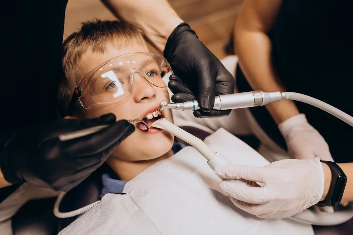 A child sitting in a dental chair while dental treatment with trusted children’s orthodontist in Charlotte, Indian Trail and Monroe, NC.